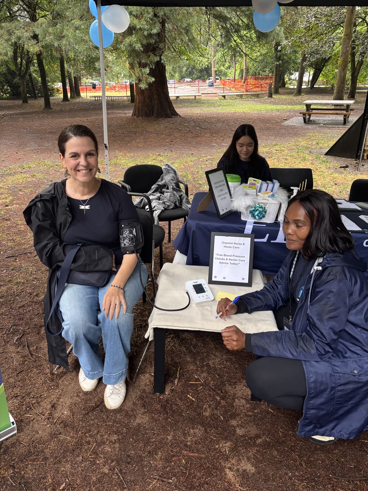 An OnPoint care aide taking a client's blood pressure during a community wellness check